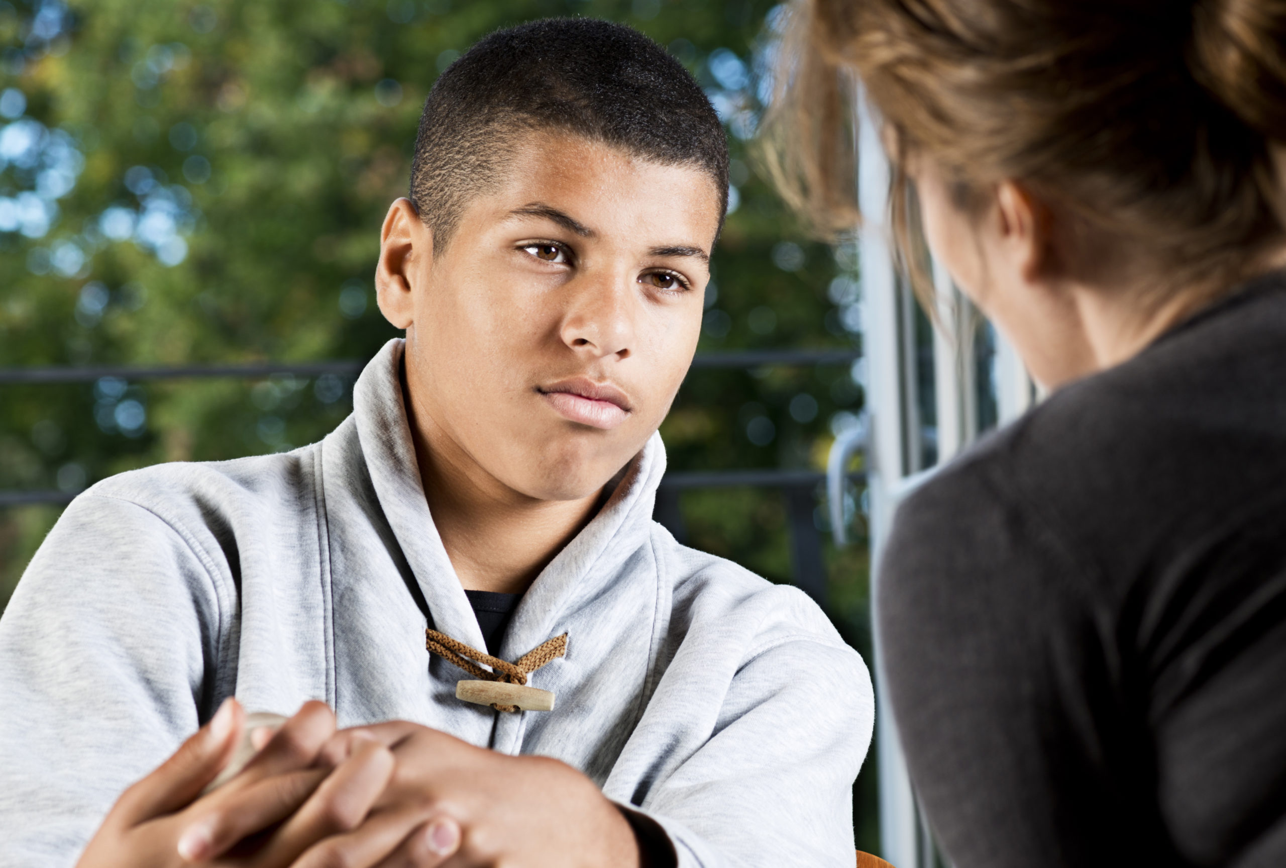 Mixed Race Teenager Talking To Counsellor Or Teacher