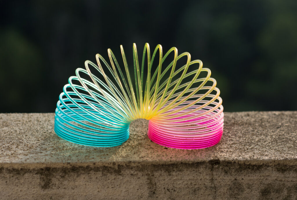 Rainbow Colored Wire Spiral Toy On White Background.
