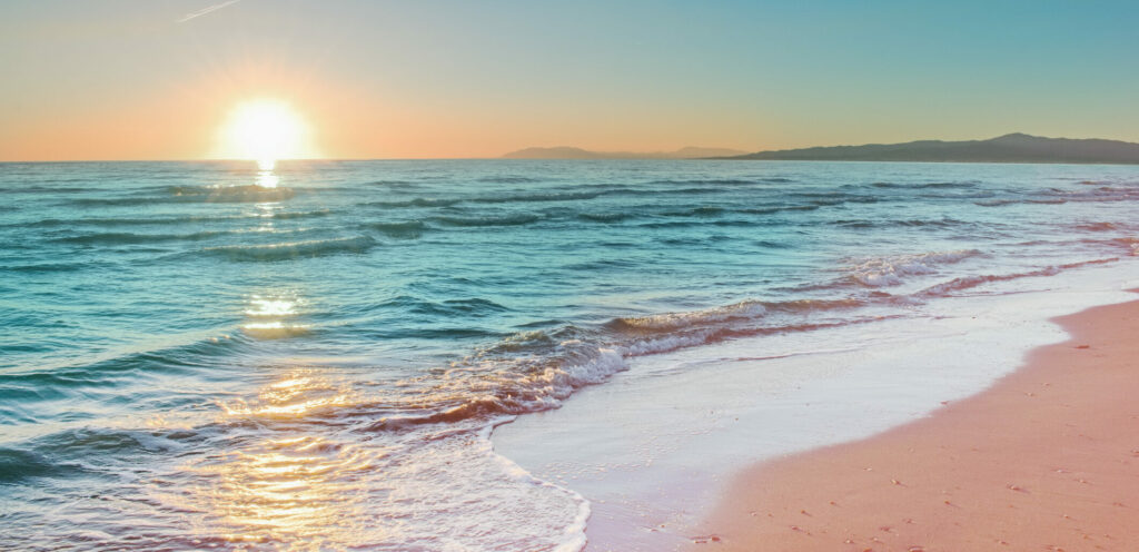 Colorful Sunset Viewed From The Pink Sea Beach With Soft Waves