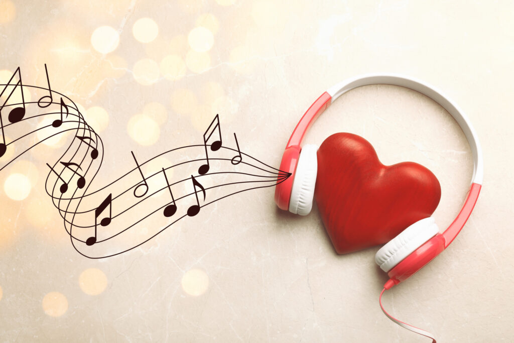 Decorative Heart With Modern Headphones On Light Background