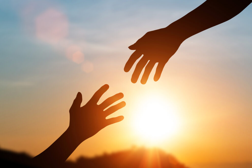 Silhouette Of Helping Hand And Develop A Friendship. International Day Of Peace Concept. Helping Hand To A Friend